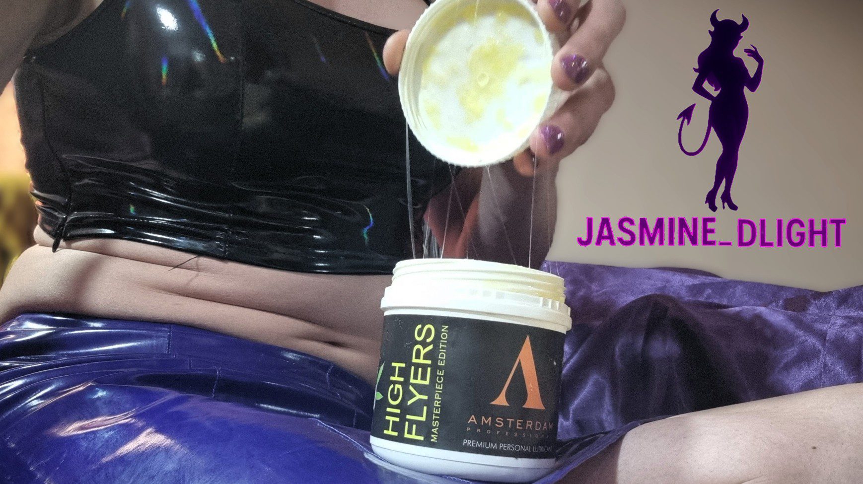 Jasmine_Dlight opens a tub of Amsterdam Professional High Flyers lube, showing its thick, glossy texture — perfect for extreme anal play.